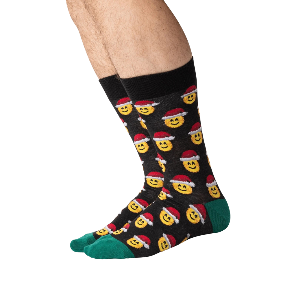 Lifestyle shot of a person wearing the Santa Smile Emoji socks. Shows how the socks look on the foot.