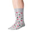 Lifestyle shot of male model wearing grey Christmas Cocktails socks.