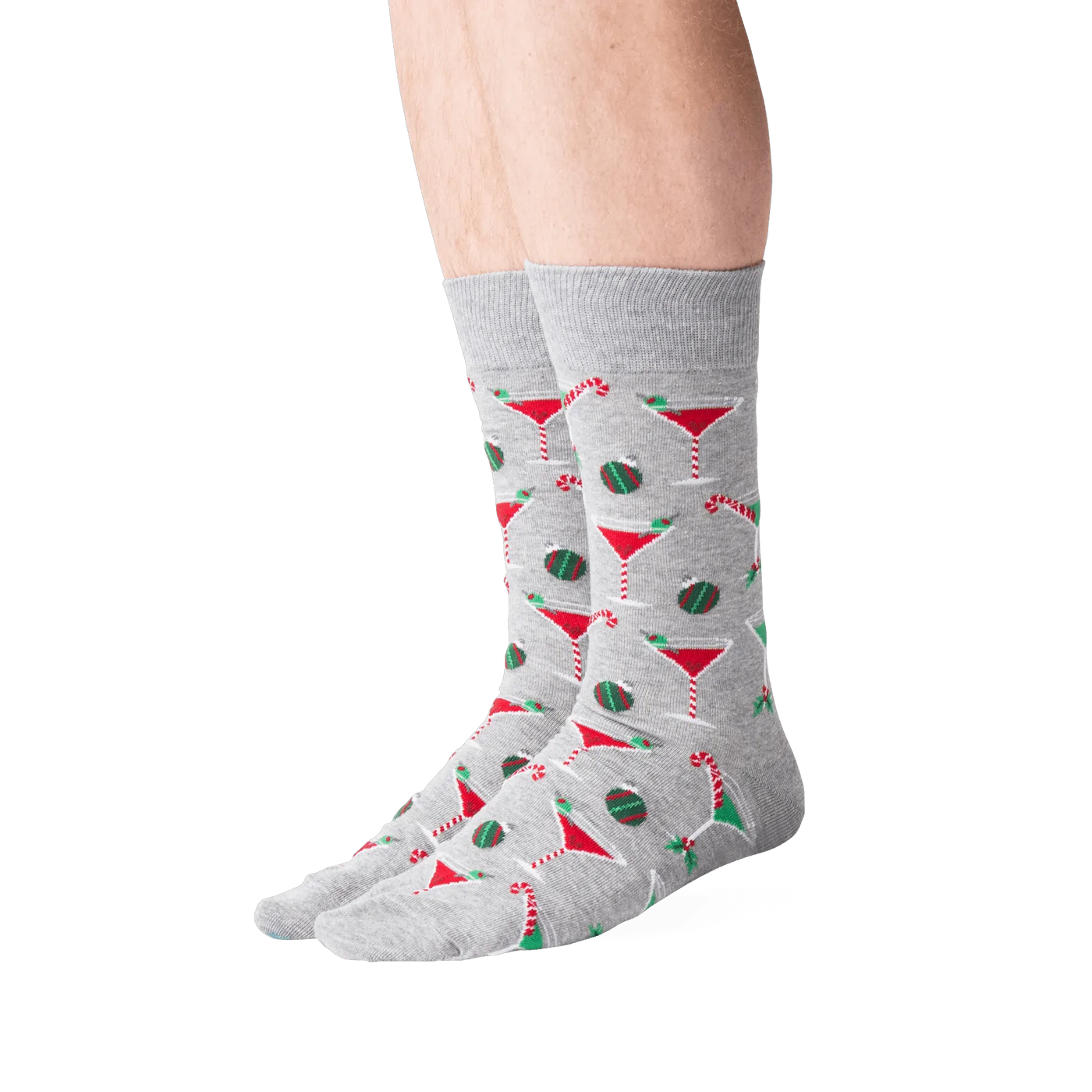 Lifestyle shot of male model wearing grey Christmas Cocktails socks.