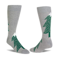 Pair of light gray crew socks with dark green evergreen tree patterns, each tree topped with a white snow peak.