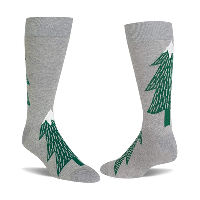 Pair of light gray crew socks with dark green evergreen tree patterns, each tree topped with a white snow peak.