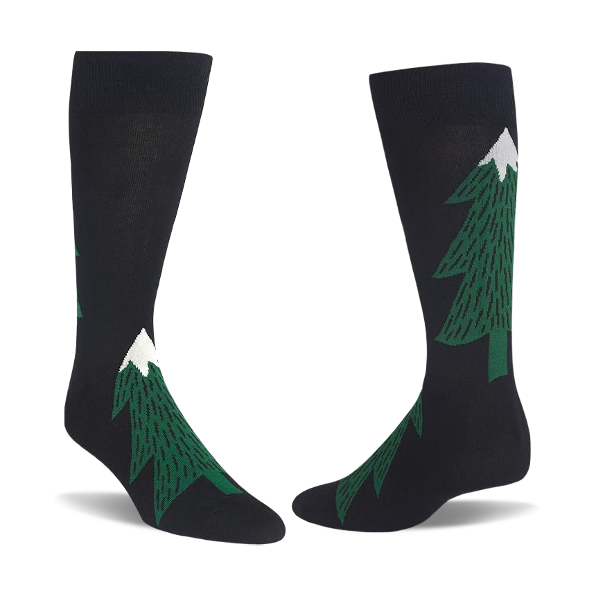 Pair of black crew socks with dark green evergreen tree patterns, each tree topped with a white snow peak.