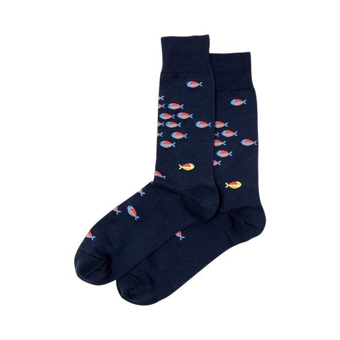 Pair of navy blue crew socks featuring a pattern of small, colorful fish in orange, red, and blue.  A few yellow fish are also visible. }}