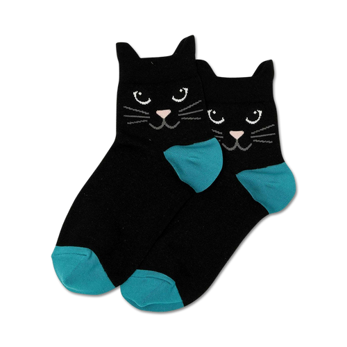 A close-up shot of a pair of black ankle socks with teal toes and cat faces. The cats have black fur, white whiskers, and black eyes.
