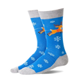 Pair of blue non-skid slipper socks with flying brown reindeer, red harness, white snowflakes, and grey cuffs, heels, toes.