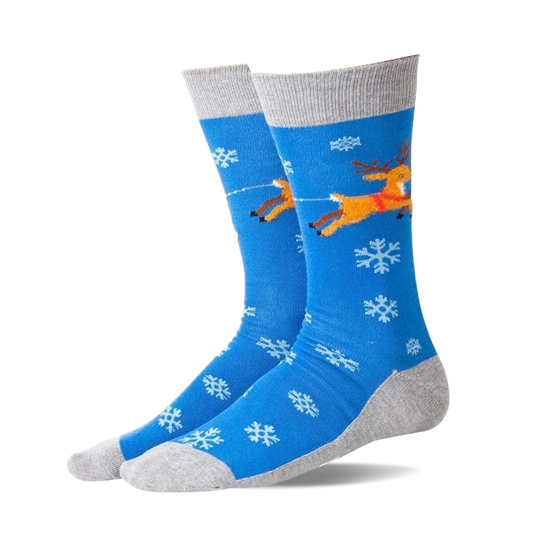 Pair of blue non-skid slipper socks with flying brown reindeer, red harness, white snowflakes, and grey cuffs, heels, toes.