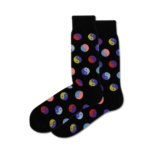 Pair of black crew socks with a repeating pattern of multicolored Yin Yang symbols.