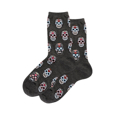 Pair of gray crew socks with a repeating pattern of colorful pixelated sugar skulls.