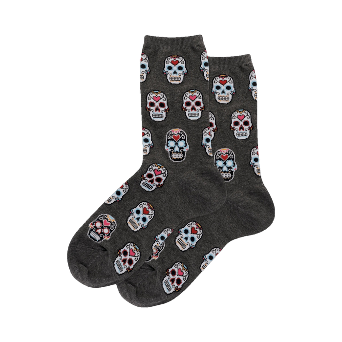 Pair of gray crew socks with a repeating pattern of colorful pixelated sugar skulls.