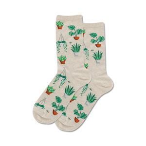 Pair of beige crew socks with a pattern of various green potted plants and small bees. 