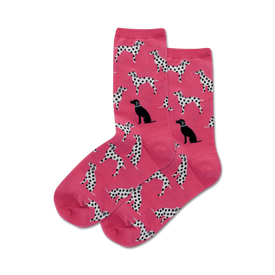 women's pink crew socks featuring a playful pattern of black and white spotted dalmatian dogs in various poses.  