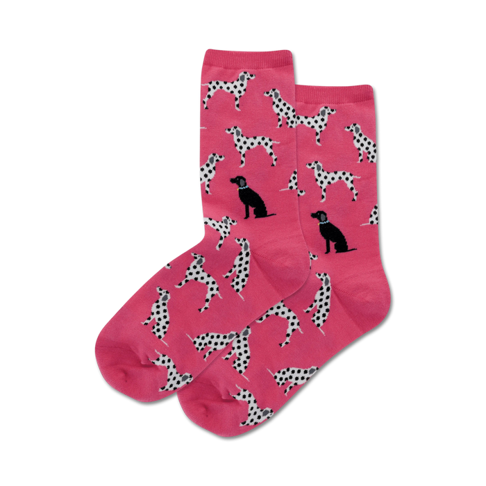 women's pink crew socks featuring a playful pattern of black and white spotted dalmatian dogs in various poses.   }}