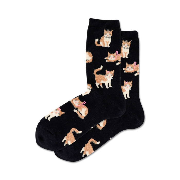 black crew socks with an allover pattern of cartoon cats in orange with white paws and a pink bow.  