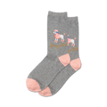 Lifestyle shot showing a pair of grey 'Fancy Bitch' socks with pink accents on a model's feet.