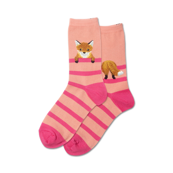 pink and orange crew socks for women with a pattern of foxes poking their heads and tails out of a striped fence.  
