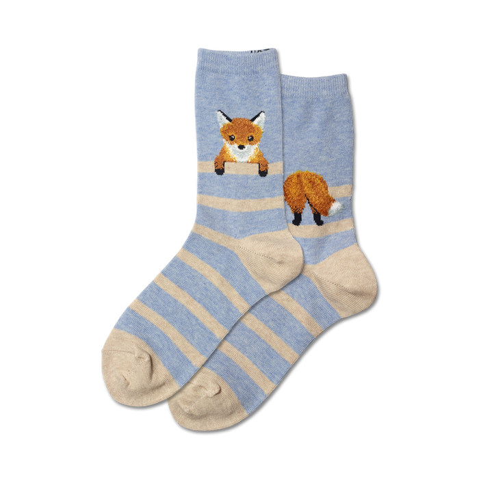 light blue women's crew socks are patterned with orange and white foxes featuring black noses and ribbed tops and reinforced toe and heel.  