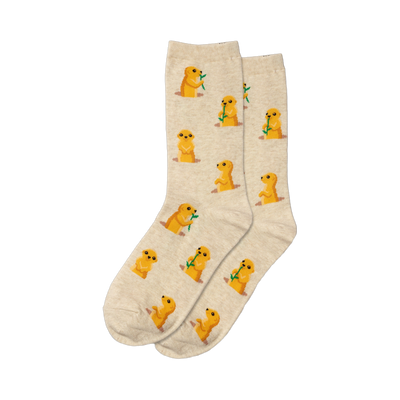A pair of beige crew socks with a repeating pattern of small, yellow prairie dogs eating green sprigs. 