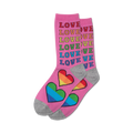 A pair of crew socks in pink with rainbow hearts and the word 'LOVE' in rainbow colors repeated vertically.