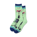 Pair of light green crew socks with a fun graphic of a drum set, electric guitar, amp, and microphone.  Navy blue and teal stripes at the cuff.