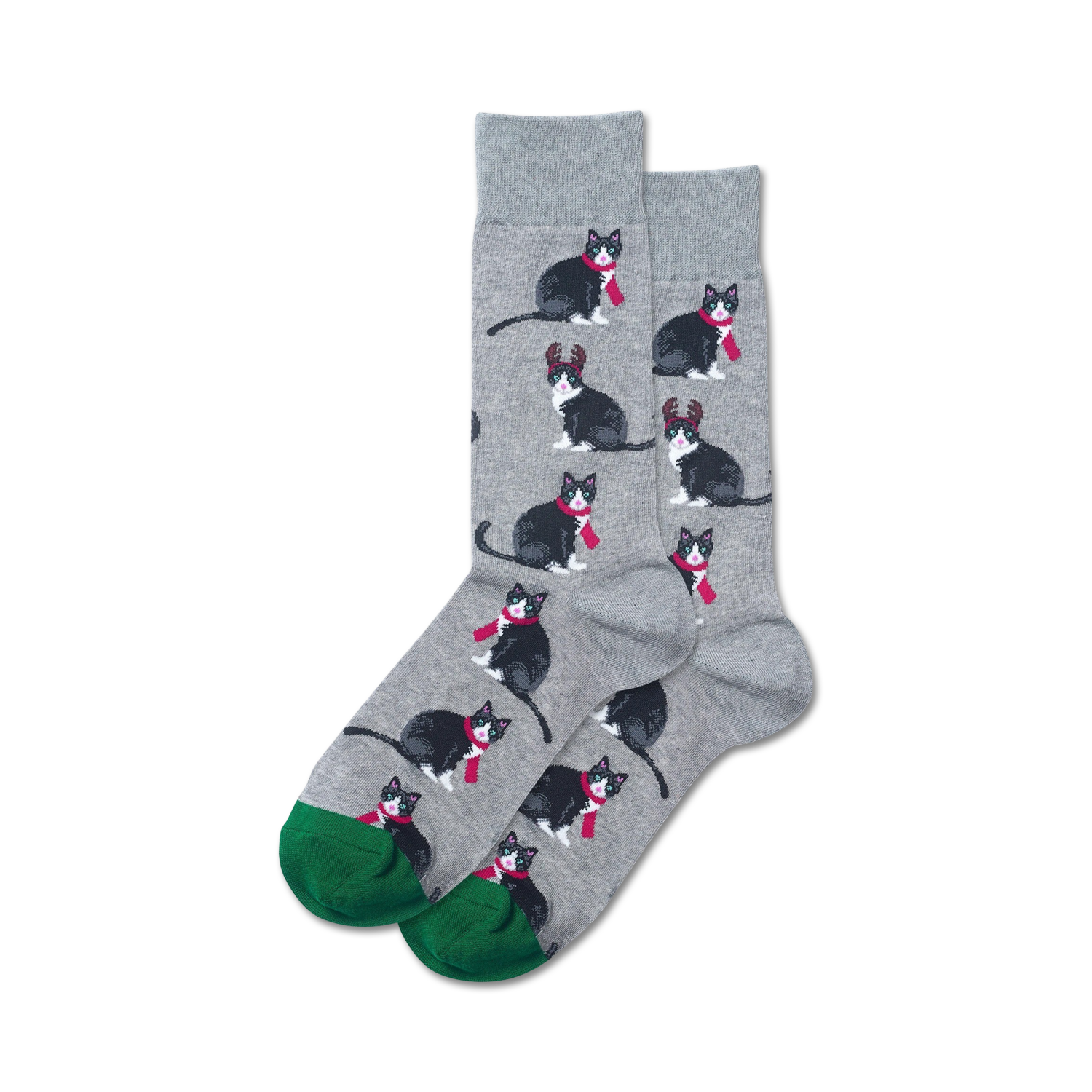 Pair of crew socks; gray background with repeating pattern of black tuxedo cats wearing red scarves and reindeer antlers; green cuffs.