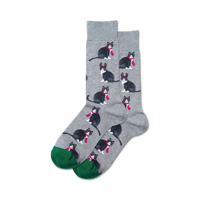 gray crew socks featuring black cats with red scarves and reindeer antlers with green toes and heels.  