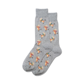 mens crew socks with a gray background featuring a pattern of brown reindeer ice skating on a light blue background.  