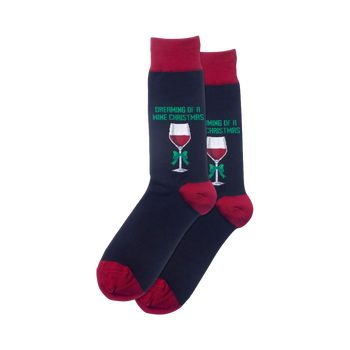 Pair of navy blue crew socks with burgundy cuffs.  Each sock shows a red wine glass with a green bow and the text 'Dreaming of a Wine Christmas'.