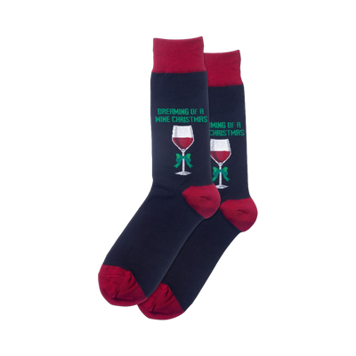 Pair of navy blue crew socks with burgundy cuffs.  Each sock shows a red wine glass with a green bow and the text 'Dreaming of a Wine Christmas'.
