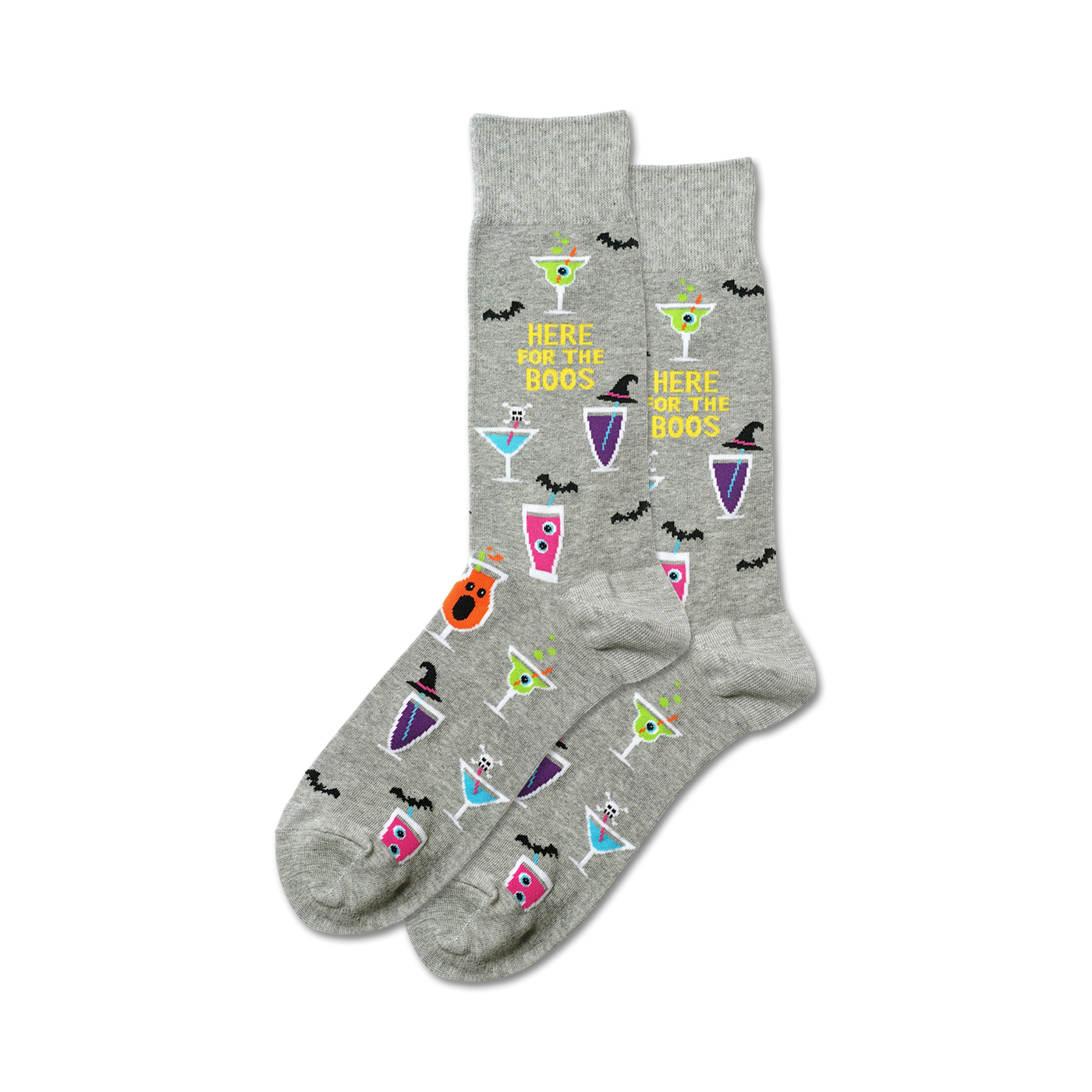 A pair of grey crew socks with a Halloween theme. The socks feature colorful cocktail designs, bats, and the text 'Here For The Boos'.