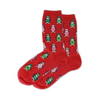 Pair of red crew socks with a pattern of penguins wearing colorful knit sweaters. Green, pink, and white accents.