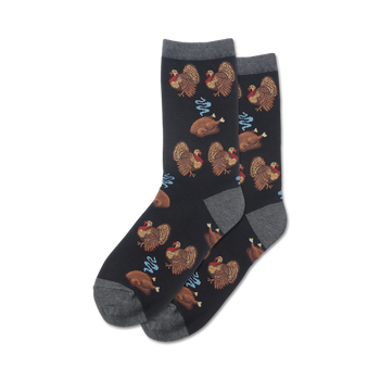 black crew socks with cartoon turkeys wearing pilgrim hats and roasted turkeys with drumsticks. perfect for turkey day or thanksgiving.   
