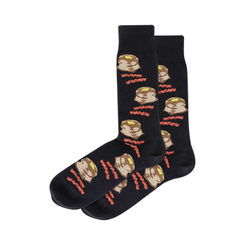 Pair of dark crew socks with a repeating pattern of illustrated pancakes and bacon strips.  Pancakes are light brown with yellow butter; bacon is reddish-brown.