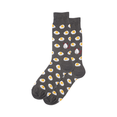 A pair of dark gray crew socks with a repeating pattern of yellow deviled eggs. Two eggs have small red devil horns and tails.