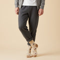 Model wearing beige crew socks with coffee cups, styled with cuffed grey sweatpants & hoodie on a light tan background. [lf]