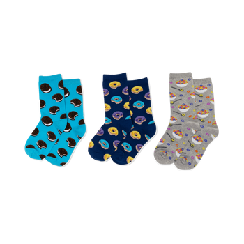 Three pairs of crew socks: light blue with sandwich cookies, navy with yellow and purple donuts, and grey with cereal bowls.