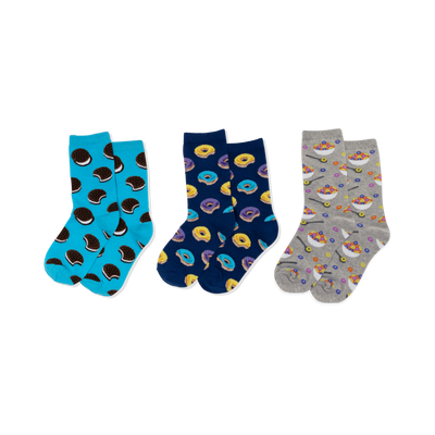 Three pairs of crew socks: light blue with sandwich cookies, navy with yellow and purple donuts, and grey with cereal bowls.