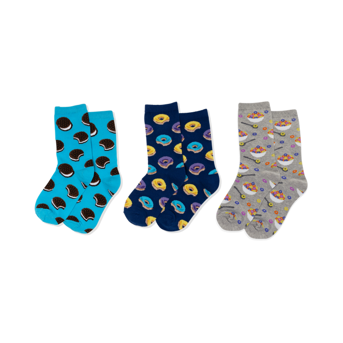 Three pairs of crew socks: light blue with sandwich cookies, navy with yellow and purple donuts, and grey with cereal bowls. }}