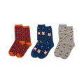 Three pairs of crew socks displayed side-by-side. Left: red-orange with blue cars. Middle: dark blue with colorful electric guitars. Right: light gray with skateboarding figures.