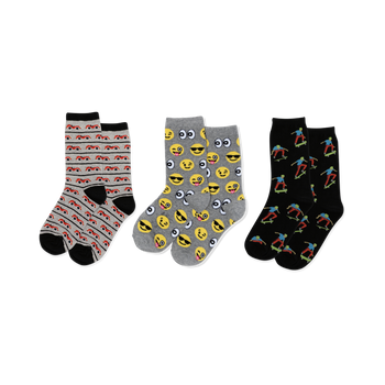 Three pairs of crew socks: light gray with red cars, gray with yellow emojis, black with colorful skateboarders, all with black accents.