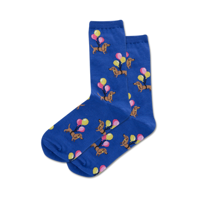 blue crew socks with a pattern of brown dachshunds wearing yellow party hats, pink, blue and yellow balloons.   