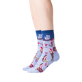 Lifestyle shot of a woman's legs wearing the light blue mermaid crew socks against a black background.