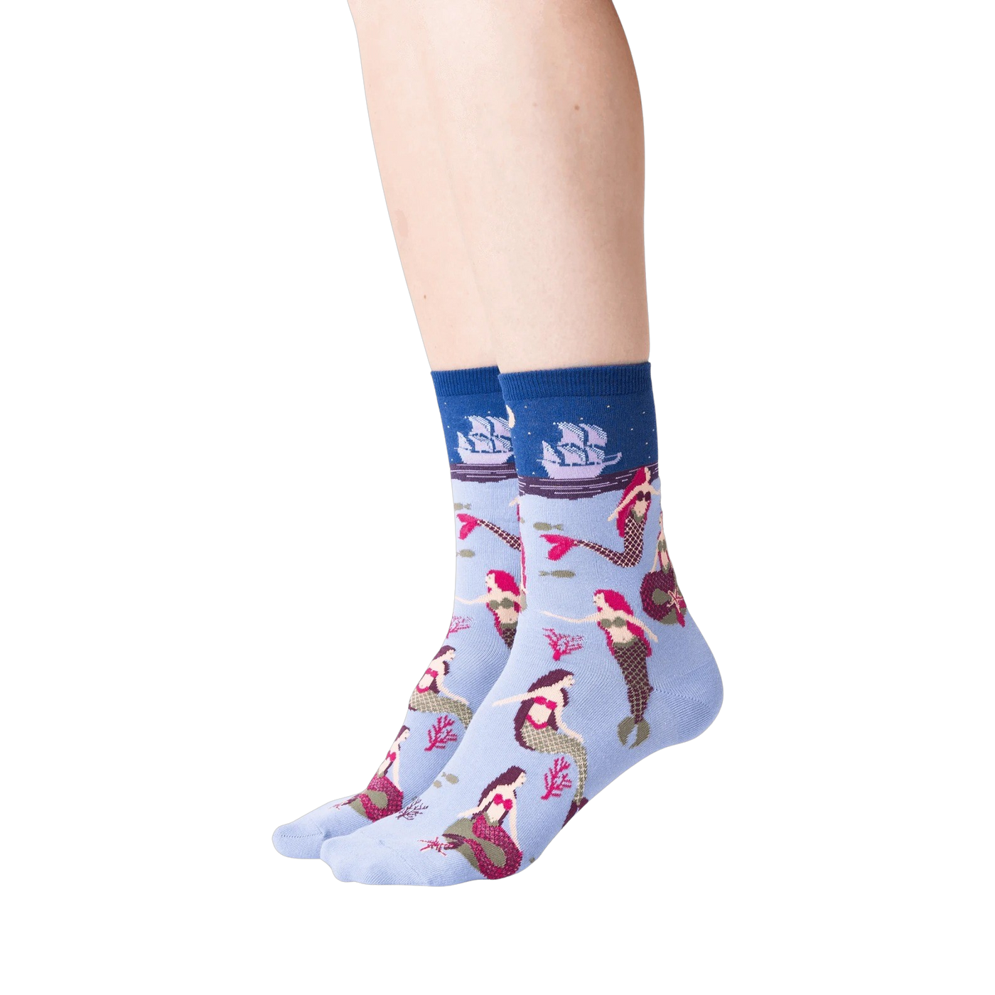 Lifestyle shot of a woman's legs wearing the light blue mermaid crew socks against a black background.