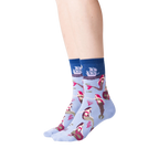 Lifestyle shot of a woman's legs wearing the light blue mermaid crew socks against a black background.