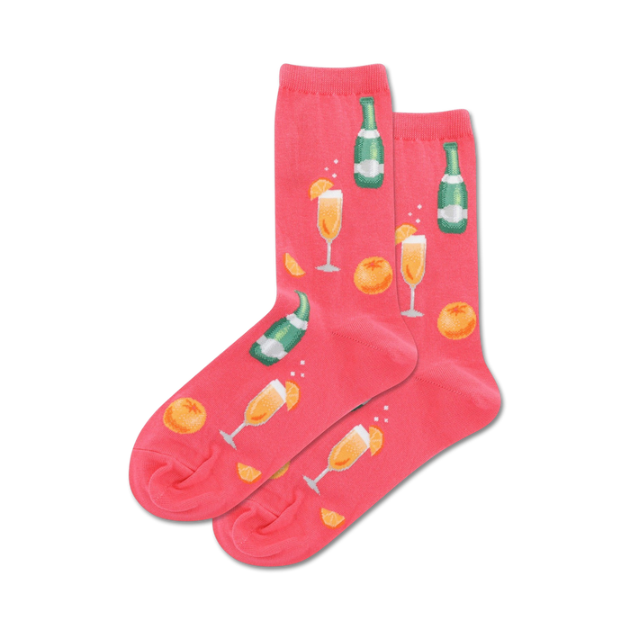 pink crew socks with a pattern of champagne flutes, orange slices, and champagne bottles.   