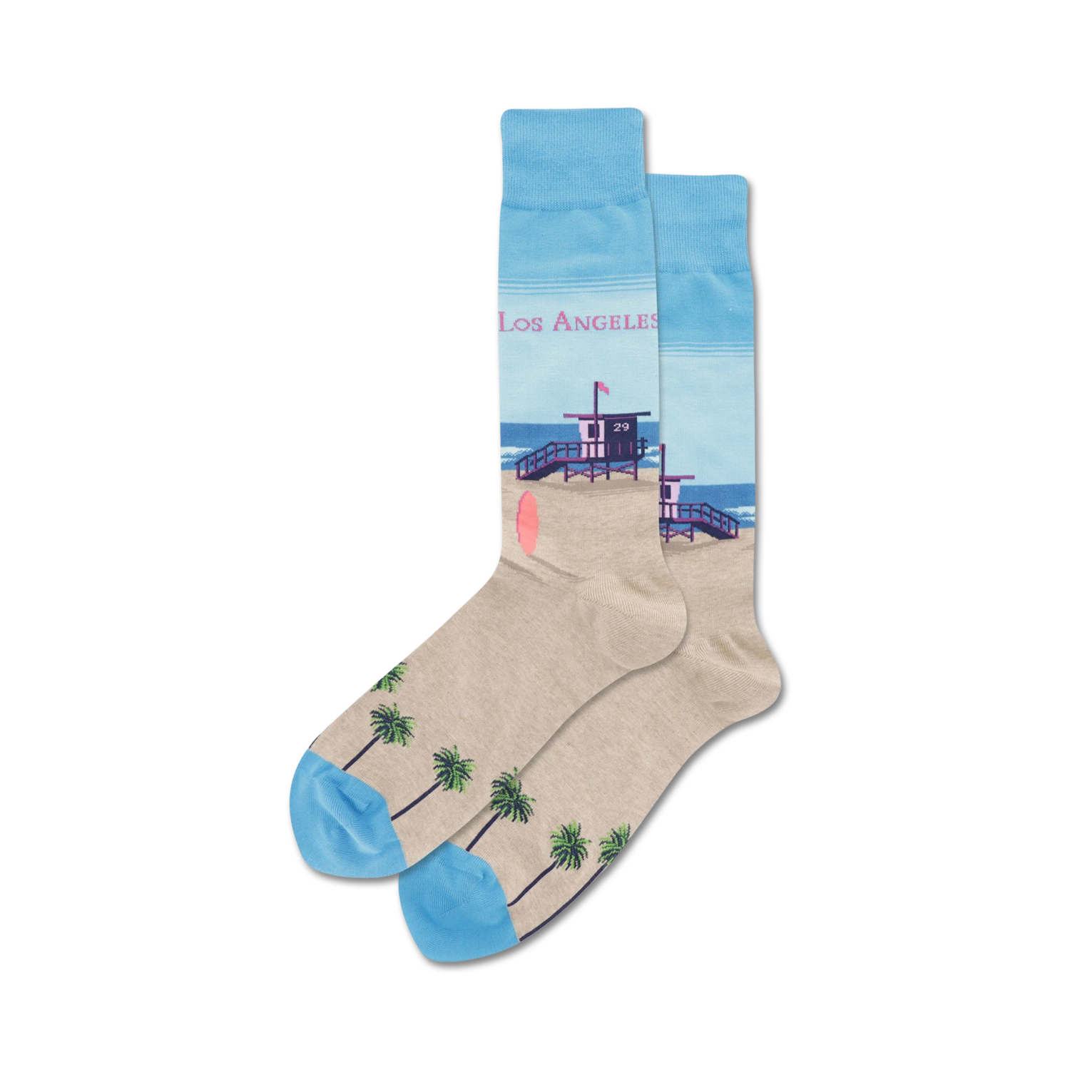 Pair of crew socks showcasing a beach scene: light beige with palm trees at the bottom, a lifeguard tower, and a light blue ocean. 'Los Angeles' text is subtly included.