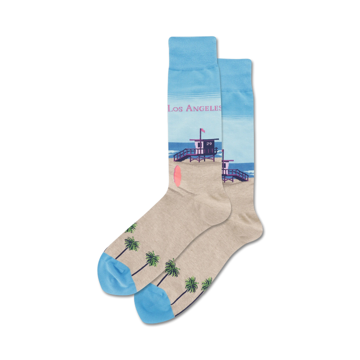 crew-length socks with a palm tree and lifeguard tower pattern in light blue, dark blue, tan, and pink for men who love the beach.    }}