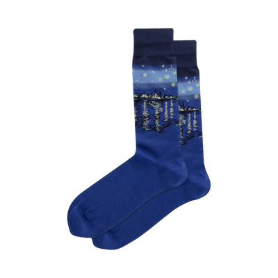 Pair of blue crew socks featuring Van Gogh's Starry Night Over the Rhone painting.  The design includes a cityscape reflected in water under a starry night sky.