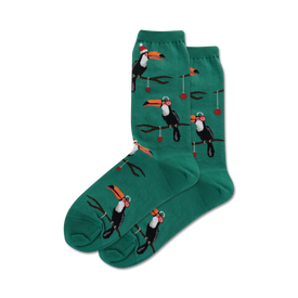 dark green crew socks with pattern of toucans wearing santa hats perched on branches with red berries. christmas themed.  