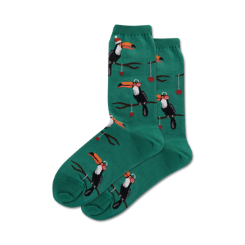 dark green crew socks with pattern of toucans wearing santa hats perched on branches with red berries. christmas themed.  