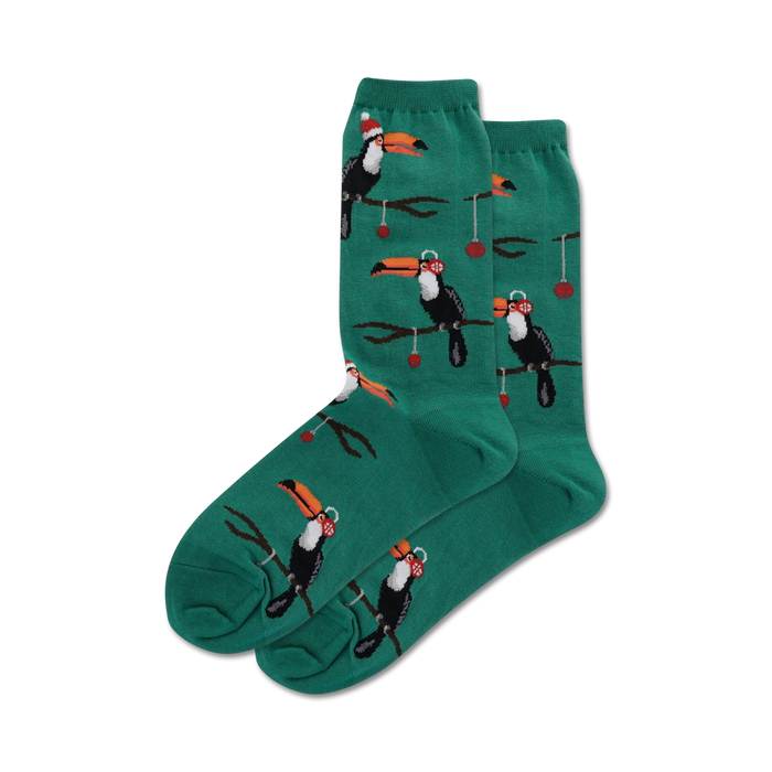 dark green crew socks with pattern of toucans wearing santa hats perched on branches with red berries. christmas themed.   }}